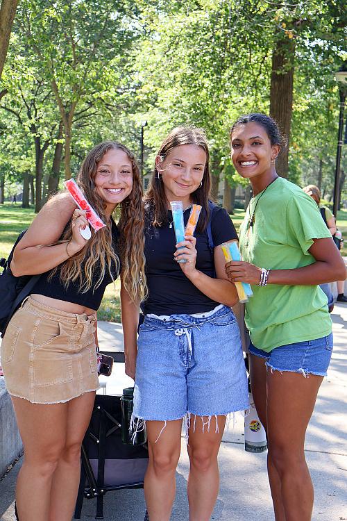 Students pose together, freeze pops in hand, during the first day of classes.